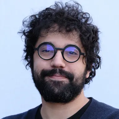 Professional headshot of Oussama Elachqar, Lead Organizer of the DCVLR competition from Oumi.